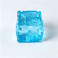 Translucent blue cheese cube squishy toy with moulded holes