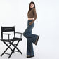 Styled outfit pairing high waist denim flares with a tucked white tee