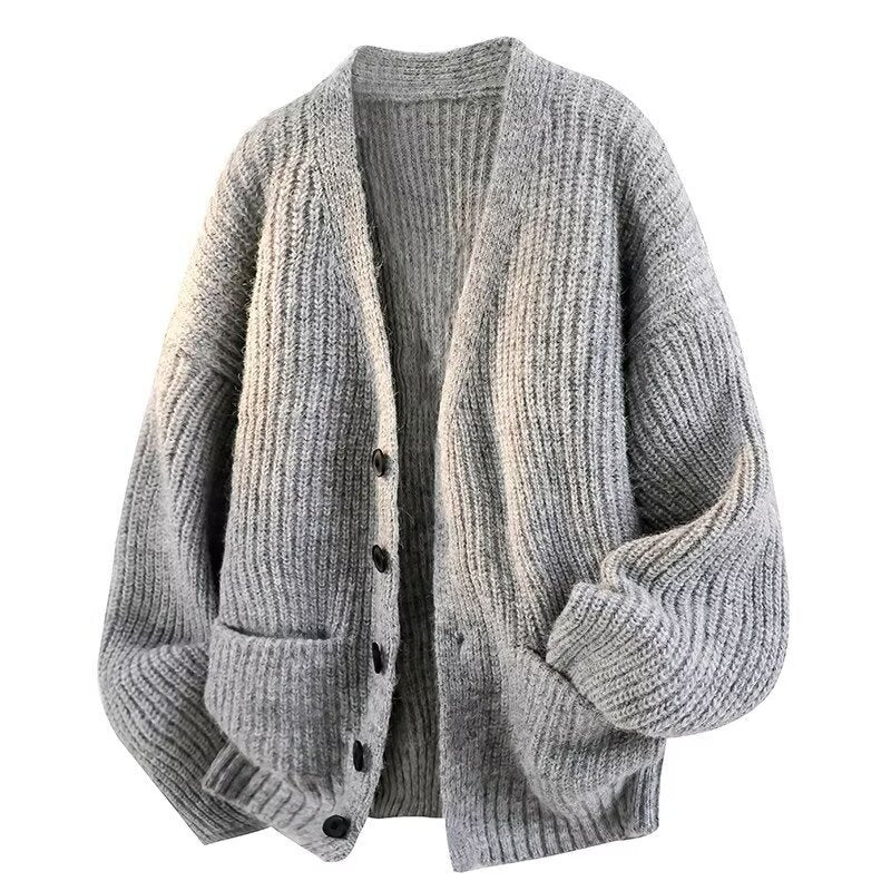 Light gray ribbed knit cardigan with a V neck, black buttons and patch pockets, front view