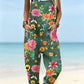 Size S option: Dark green overalls with a pink and orange floral print, cuffed legs and pockets on a beach