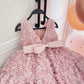 Pink rosette party dress held to show length and sizing by child height 80 to 150cm