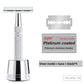 Silver chrome safety razor on a matching weighted stand with five replacement blades