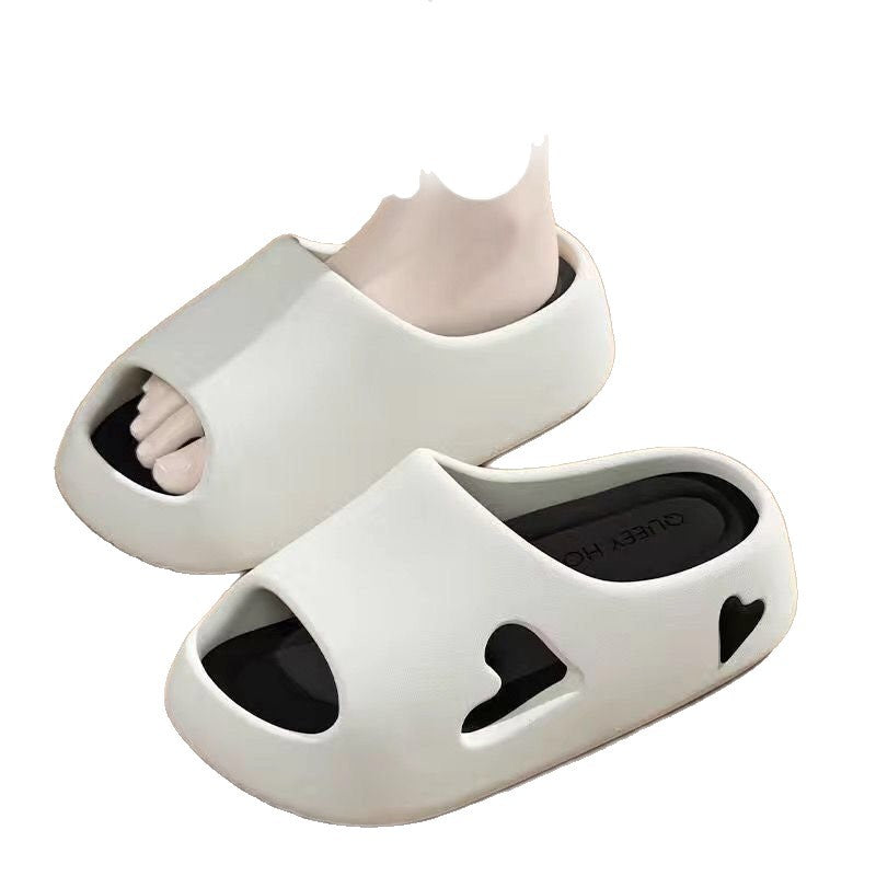 Black cushioned EVA slide sandals with pink footbed viewed from the side