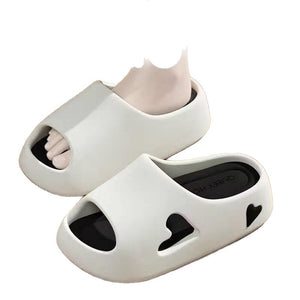 Black cushioned EVA slide sandals with pink footbed viewed from the side