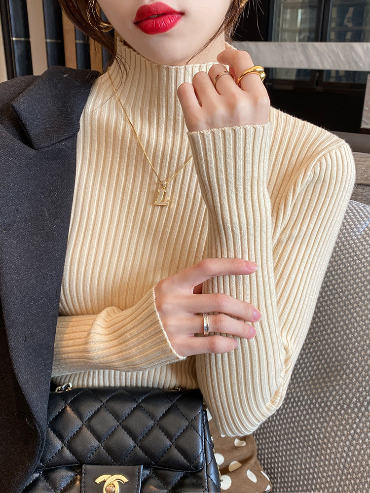 Slim fit vertical rib knit sweater with a semi high collar worn under a coat