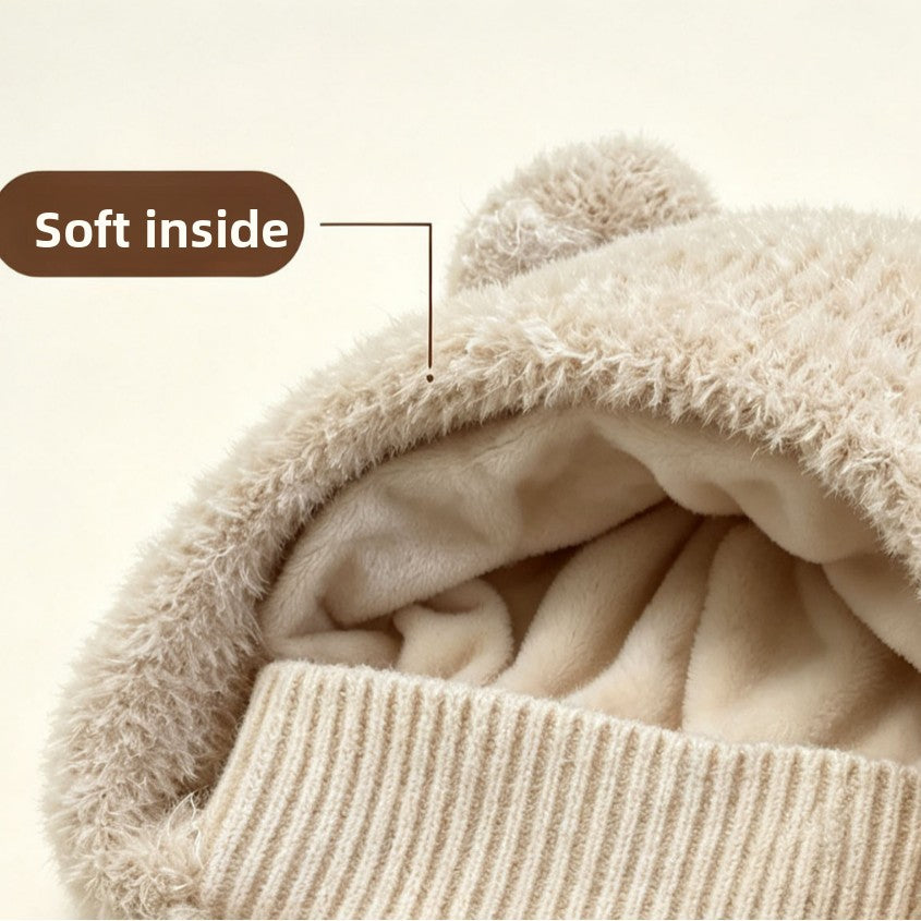 Close-up of the plush fleece lining and ribbed cuff inside a beige fluffy knit hood