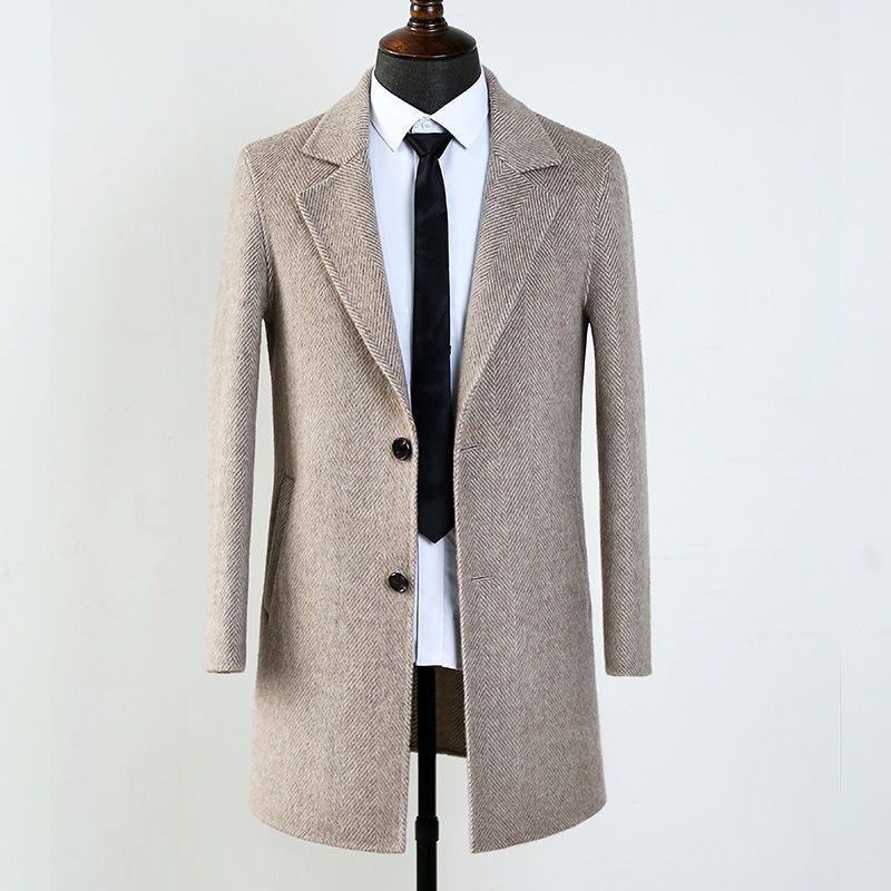 Men's herringbone wool blend overcoat styled in a neutral setting