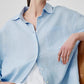 Linen shirt shown half tucked with the sleeves pushed to the elbow