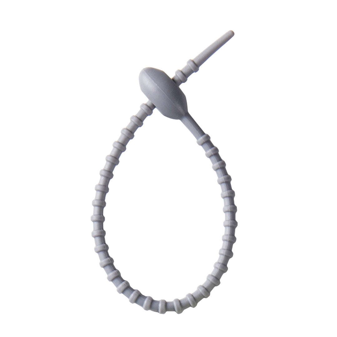 Close view of the ridged silicone strap and the tadpole head that holds the loop