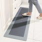 Flat quick dry bath mat angled on a bathroom floor beside a tub edge
