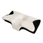 Memory foam cervical pillow with contoured butterfly shape resting on a bed