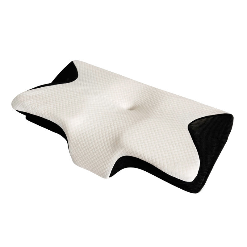 Memory foam cervical pillow with contoured butterfly shape resting on a bed
