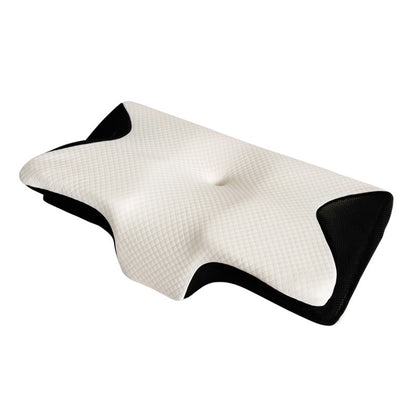 Memory foam cervical pillow with contoured butterfly shape resting on a bed