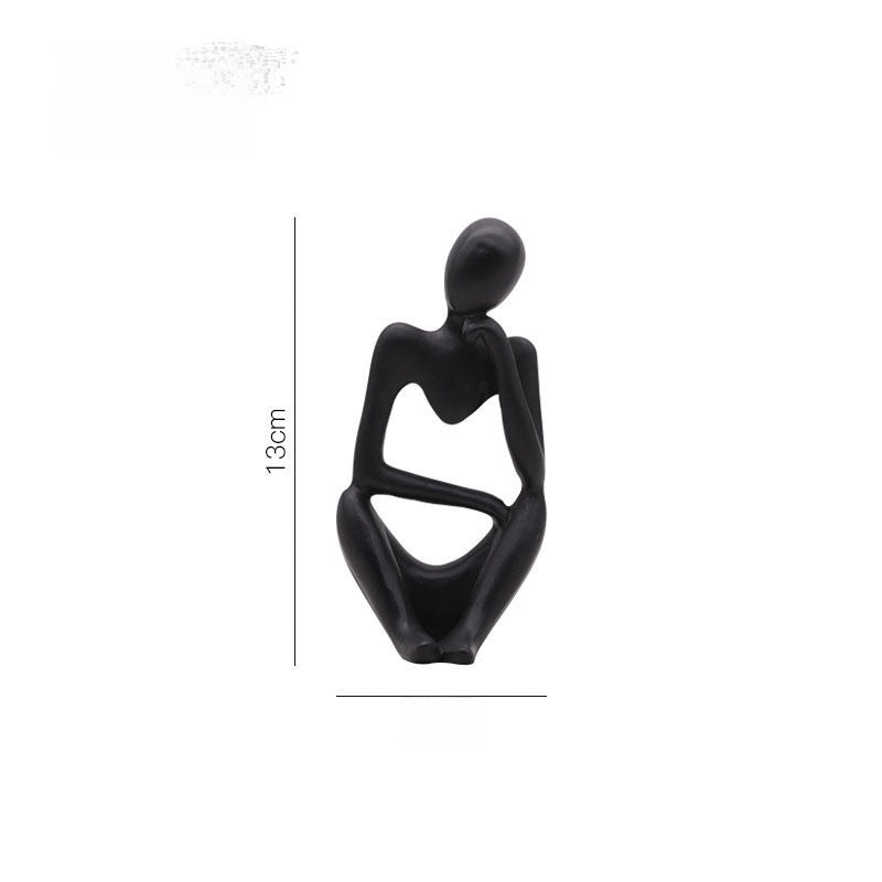 Black abstract resin meditator figurine with a 13 cm height marker on a plain background
