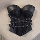 Full front of the black studded strapless bustier corset top with crossing waist straps