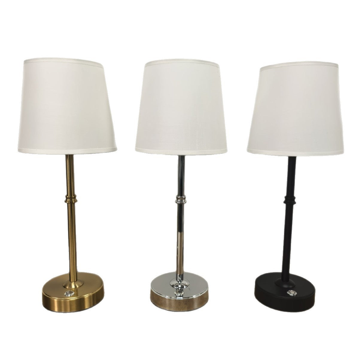 Gold, silver and black metal table lamps with white fabric shades on a white background