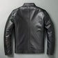 Back view of a black stand collar moto jacket with a center back seam and buckle tabs at the waist