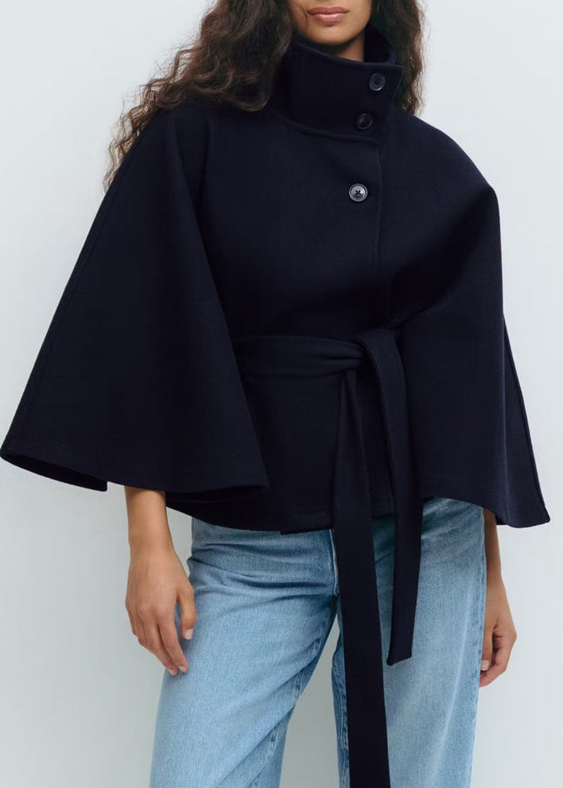 Short cape jacket with cape cut sleeves and a matching self tie belt at the waist
