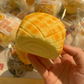 Soft pineapple bun squishy denting under a child's thumb during a squeeze