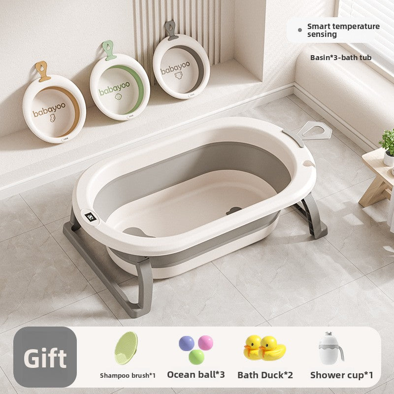 Empty cream and gray baby bathtub with three round washbasins hung on the bathroom wall