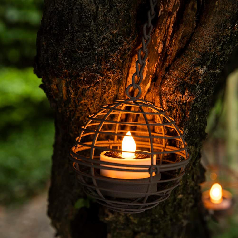 Solar candle ball lantern held in hand for scale reference