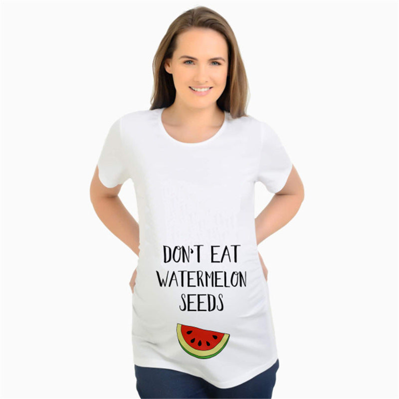 White maternity short sleeve tee with a Do Not Eat Watermelon Seeds print, round neck and side ruching, on a pregnant model