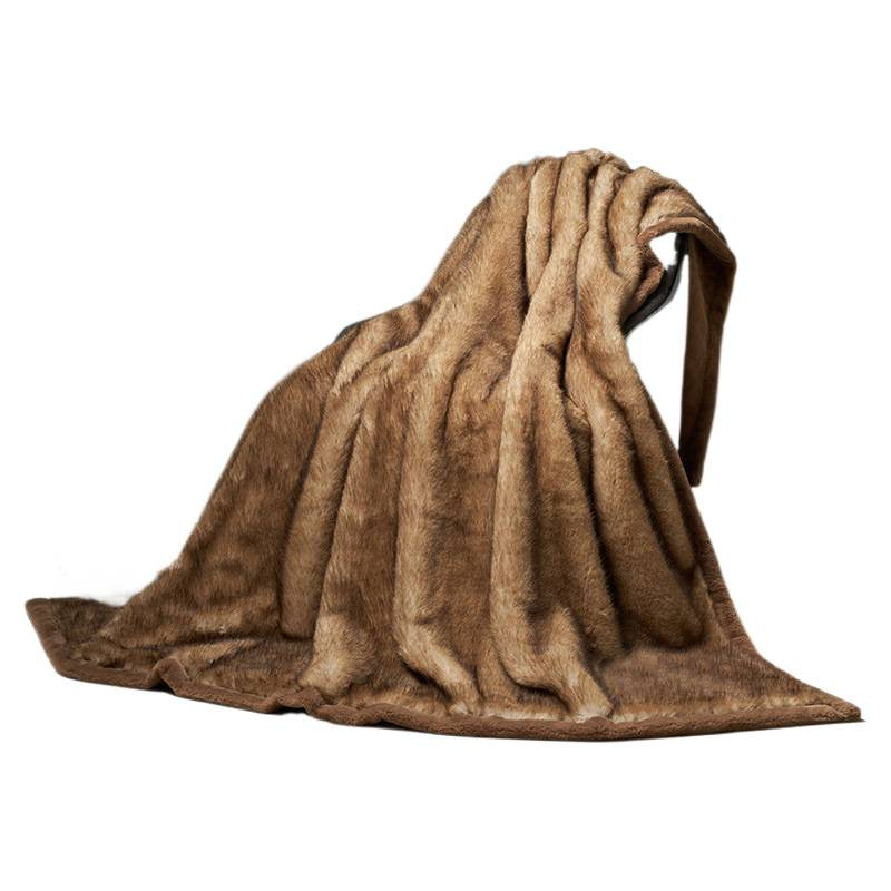 Camel vegan fur blanket draped over a surface on a white background, showing the pile and the dark backing