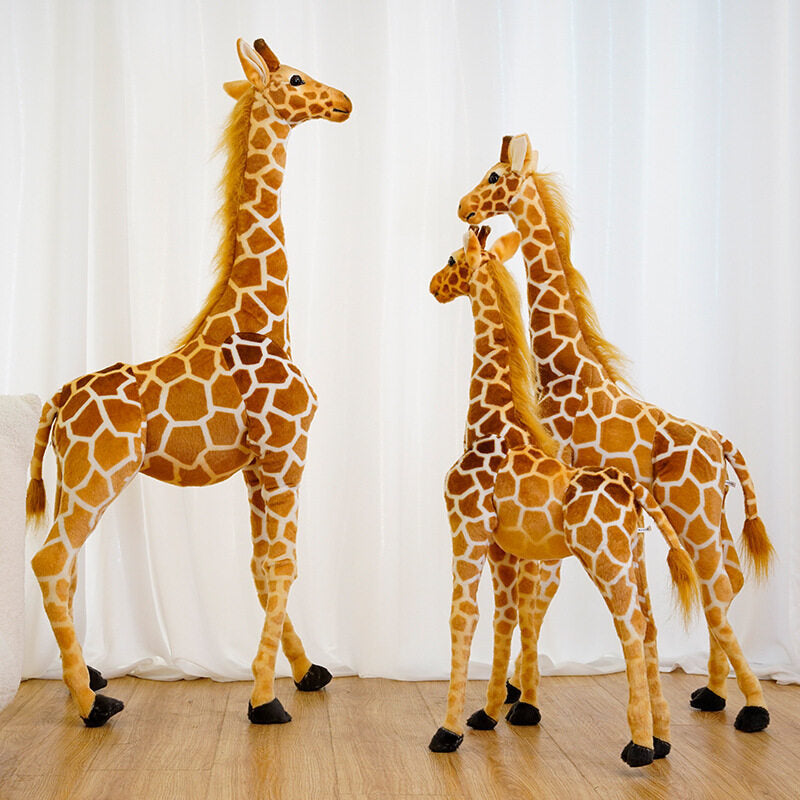 Group of standing giraffe plush toys in graduated heights posed together on a wooden floor