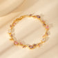 Gold zircon leaf bracelet worn on the wrist during an everyday moment