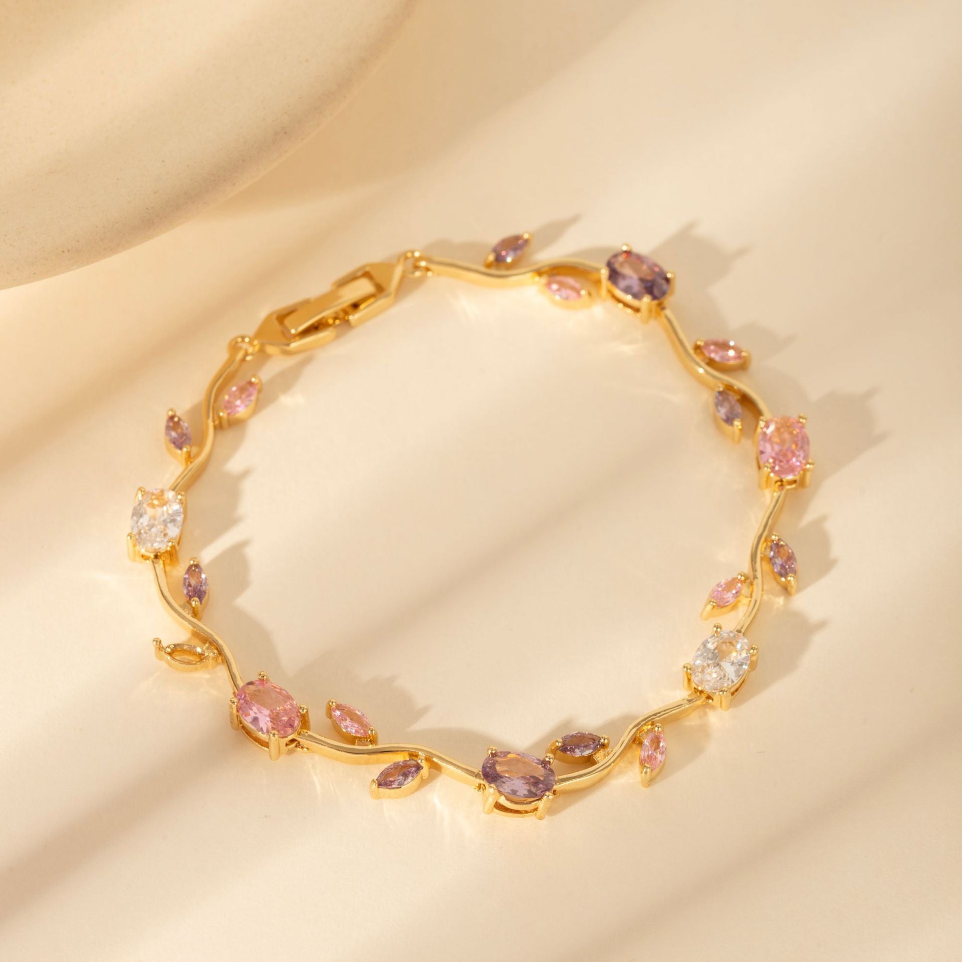 Gold zircon leaf bracelet worn on the wrist during an everyday moment