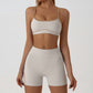 Close view of the contrast piping tracing the bust seams of the strappy sports bra