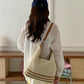 Soft cream crochet style shoulder bag with a slim brown adjustable strap