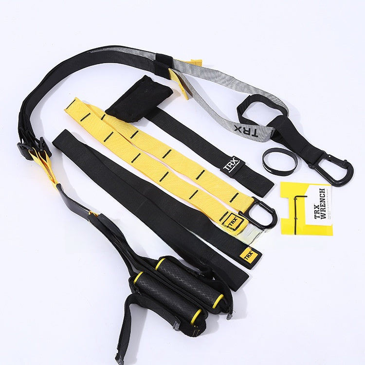 Black and yellow TRX suspension straps foam handles and carabiner arranged on white surface