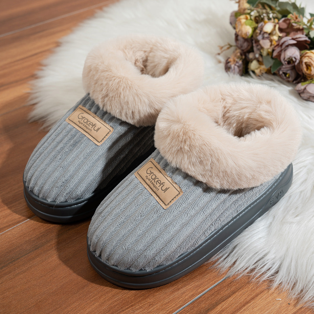Close up of the faux fur collar and stitched suede look upper of a winter slipper