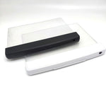 Slim LED reading light panel laying flat and glowing on an open book