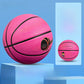 Pink rubber basketball for beginners angled on a bright studio background