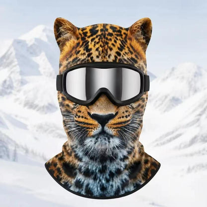 Leopard print fleece balaclava with ears and silver goggles on a snowy mountain