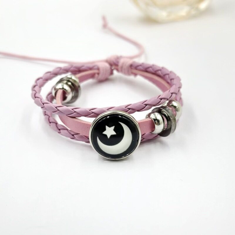 Black braided cord bracelet with a round sun charm and silver tone beads
