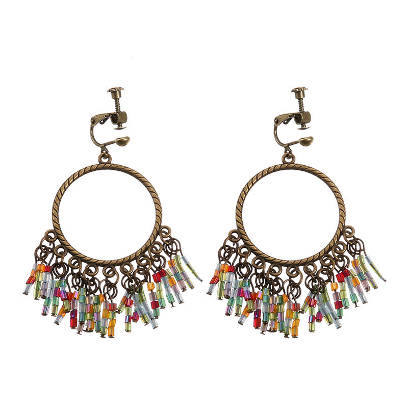 Bohemian vintage clip-on tassel drop earrings on a zinc alloy frame, handmade boho pair on white studio background
