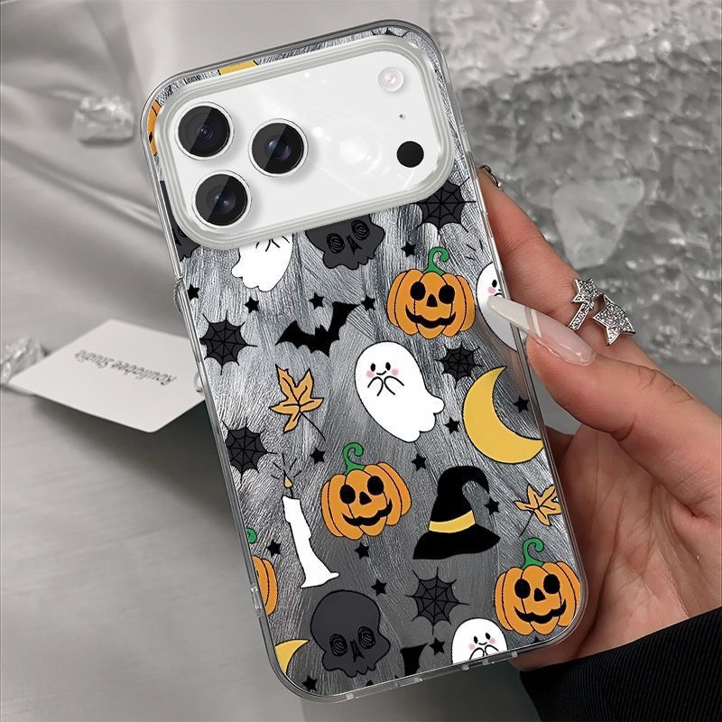 Silver shimmer iPhone case printed with ghosts, pumpkins, bats, skulls and a witch hat, held in a hand