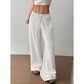 High waist wide leg crinkle cotton trousers shown front on with an elastic drawstring waist