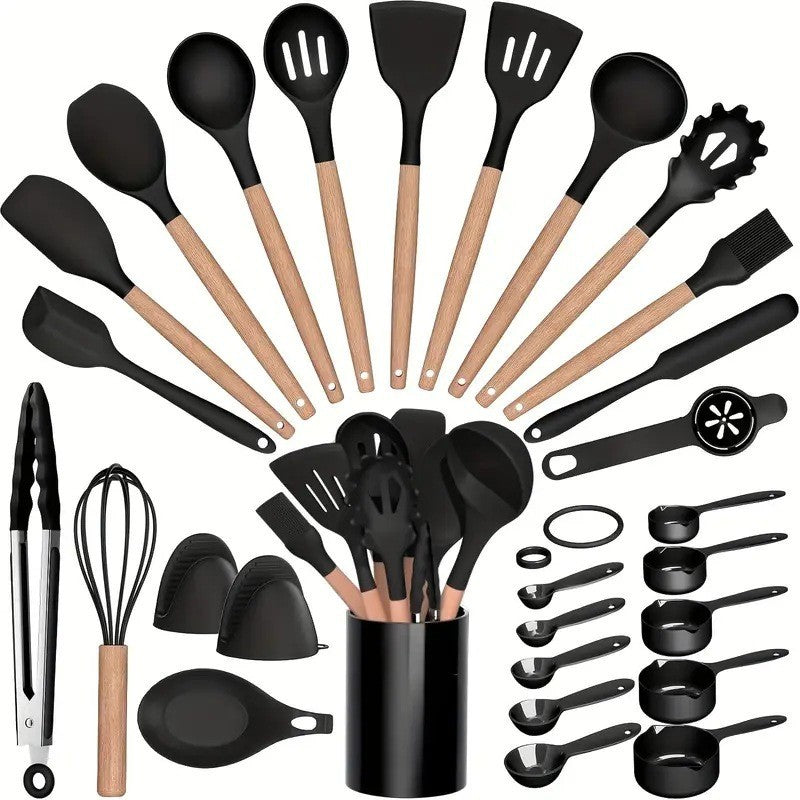 Black silicone kitchen utensil set with beech handles arranged in an arc around the matching crock