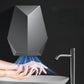 Dark gray automatic hand dryer blowing warm air onto hands over a sink
