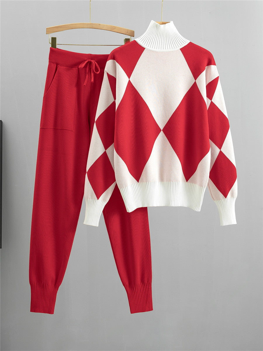 Red argyle knit sweater with white panels and matching red drawstring jogger pants on hangers against a white background