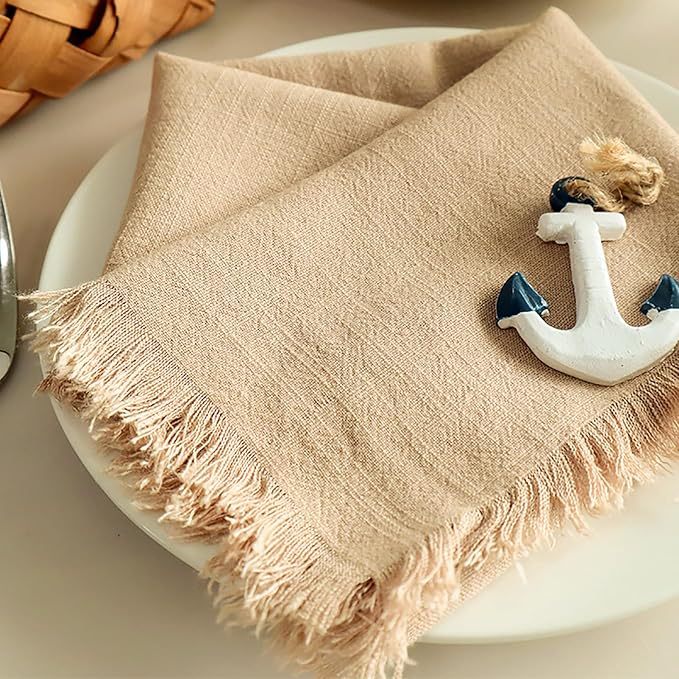 Side angle of a folded 45x45cm raw edge cotton linen napkin