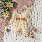 Baby floral romper laid flat as a sizing and set reference