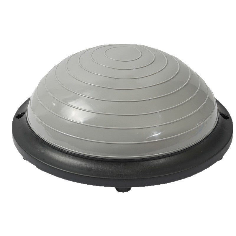 Grey half dome balance trainer seen from the side, dome and rigid black base together