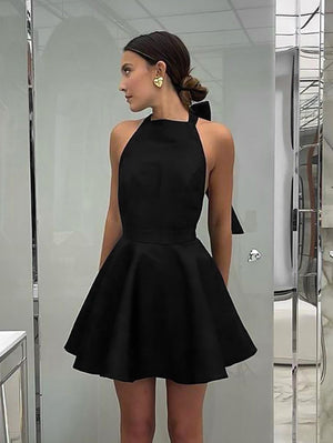 Black halter dress showing lace-up bow at the neckline