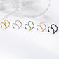 Five double line ear cuffs in gold, steel, rainbow, rose gold and black