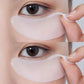 Under-eye gel patch pressed below the eye during a quiet skincare rest